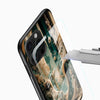 Teal and gold Glass Mobile Cover close-up featuring intricate forest artwork and detailed botanical elements